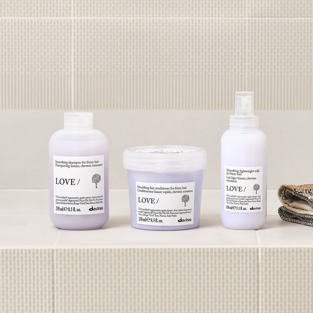 Davines LOVE Smoothing Conditioner with the LOVE Smoothing range on a bathroom shelf